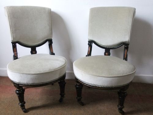 a pair of ebonized chairs