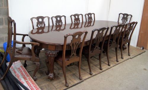 a truly exceptional mahogany claw and ball chippendale style extending table and matching 10 chairs
