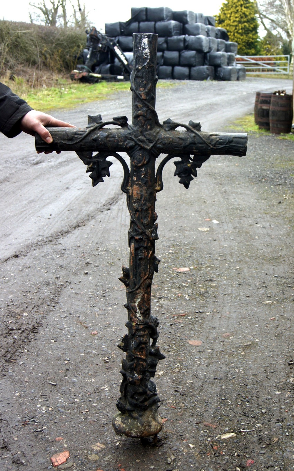 a very heavy quality cast iron cross with vines and leaves
