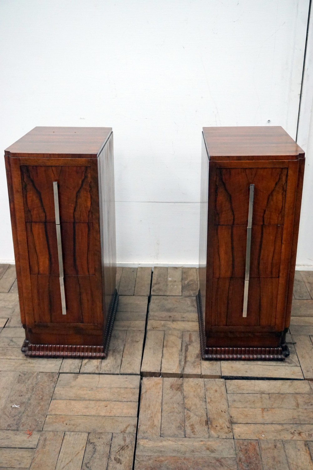 a pair of walnut deco bedside chests