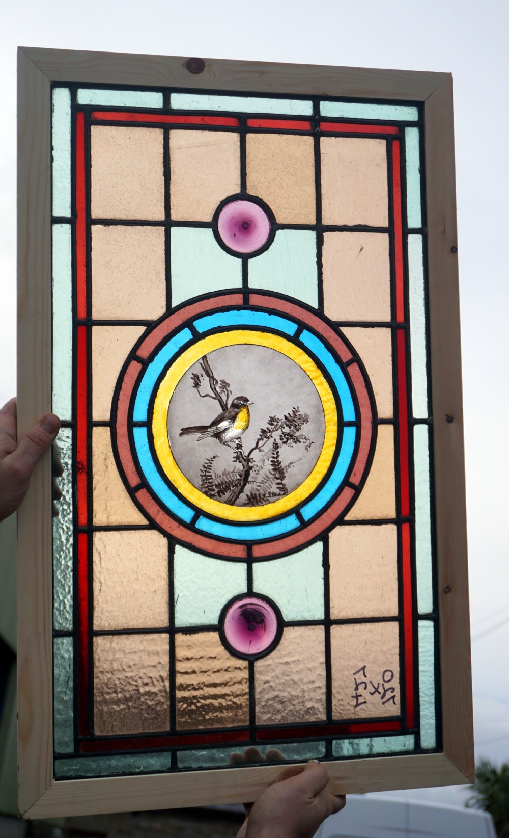 a beautiful stained glass painted bird window