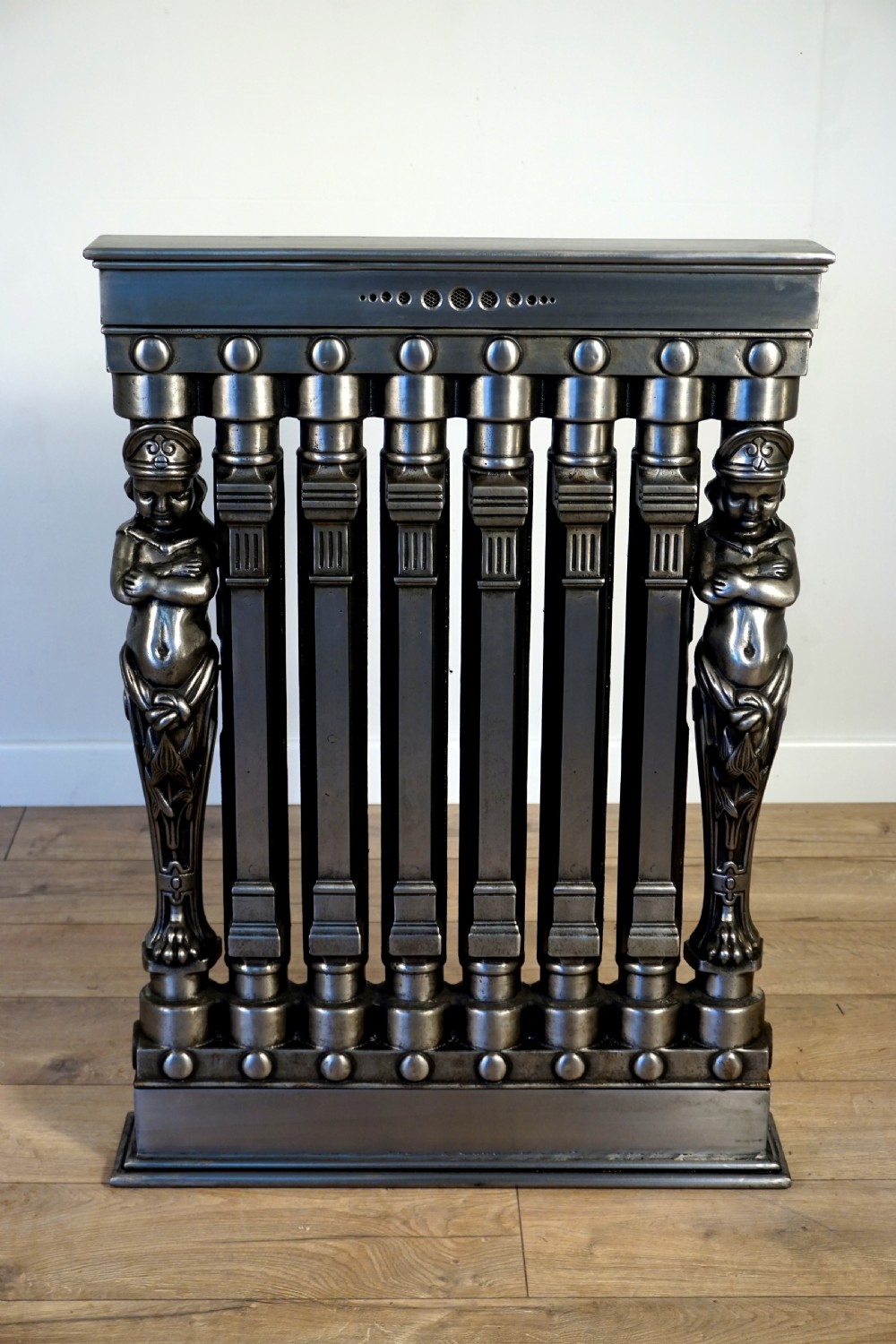 an exceptionally rare set of 3 cast iron early 20th century figural ventilo radiators