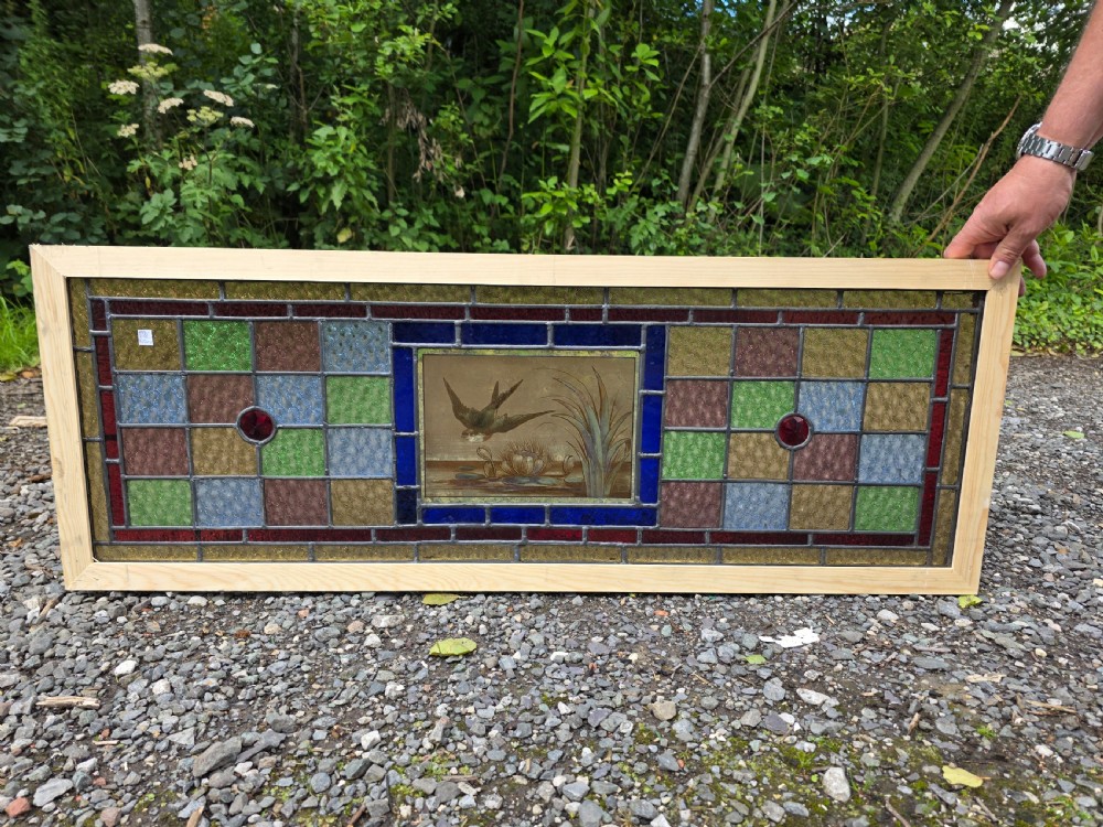 1900 antique leaded glass window with bird on flight design